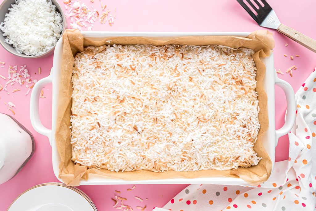 toasted coconut cake bars in a baking dish