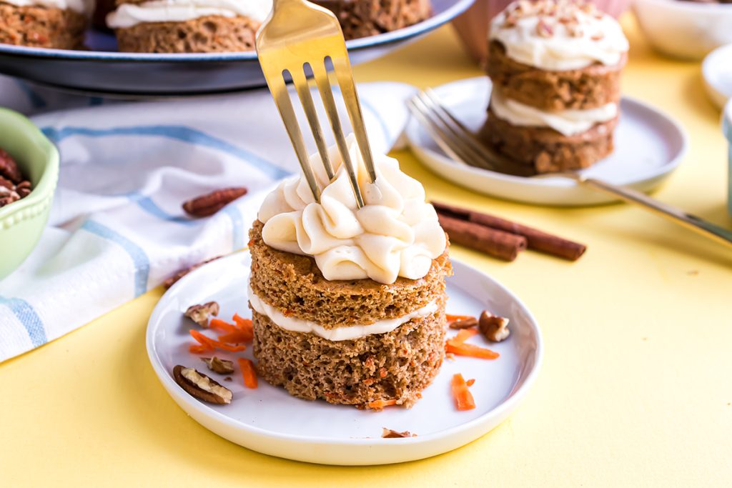 gold fork digging into mini carrot cake