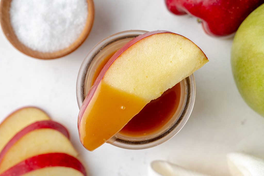 apple dipped into caramel sauce