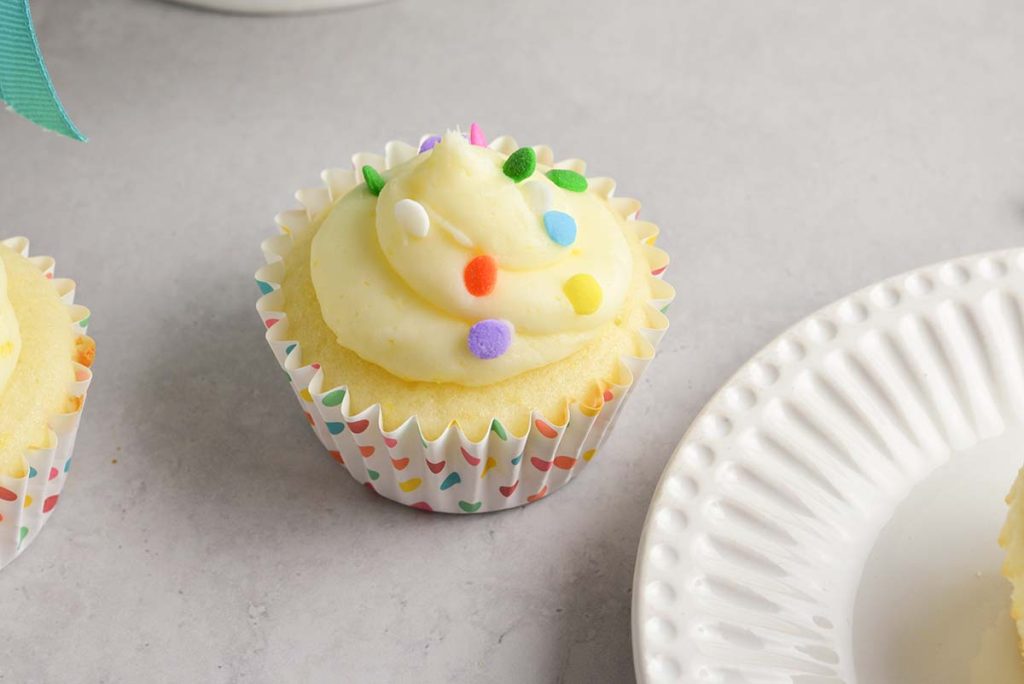 one lemon cupcake topped with sprinkles