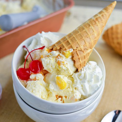 mango ice cream on a cone in a bowl