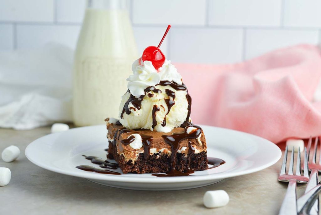 mississippi mud brownie topped with ice cream and whipped cream