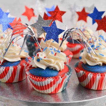red white and blue cupcakes on a stand