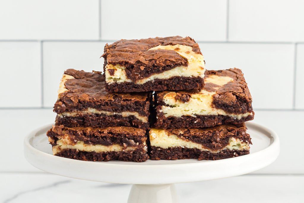 brownie cheesecake bars on a tray