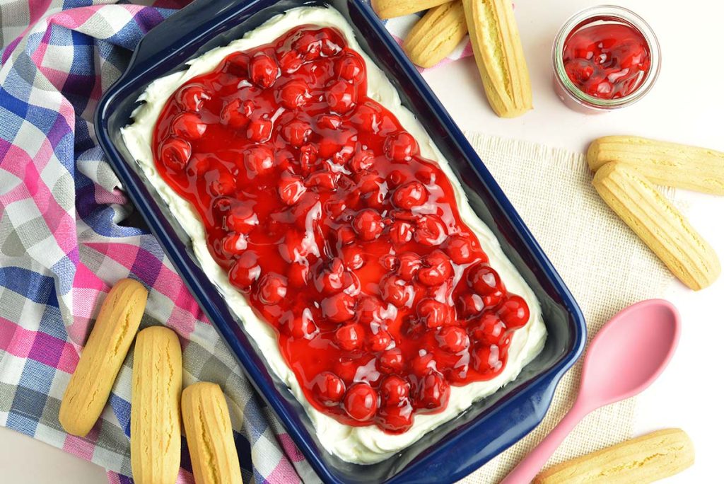 overhead of cherry cheesecake dip in a blue serving dish