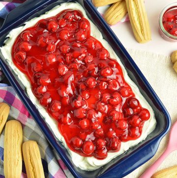 overhead of cherry cheesecake dip in a blue serving dish