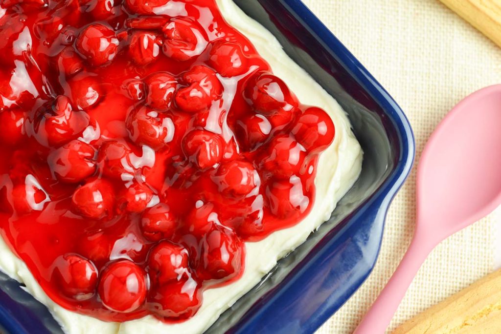 overhead angle cheesecake dip with pink spoon