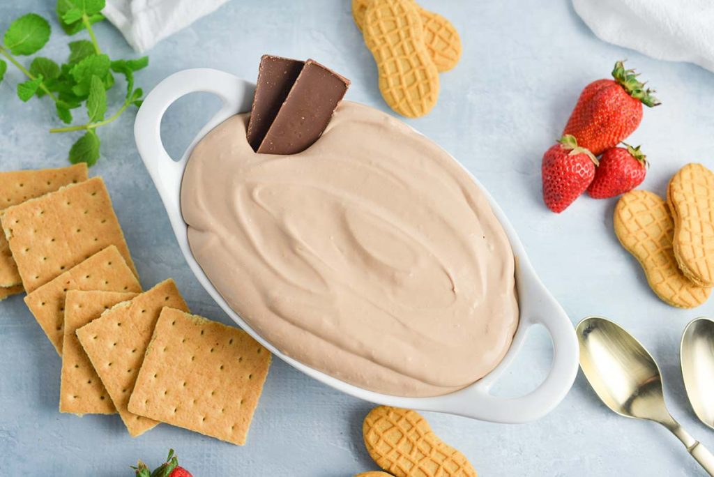 Overhead of creamy chocolate cheesecake dip with two pieces of chocolate