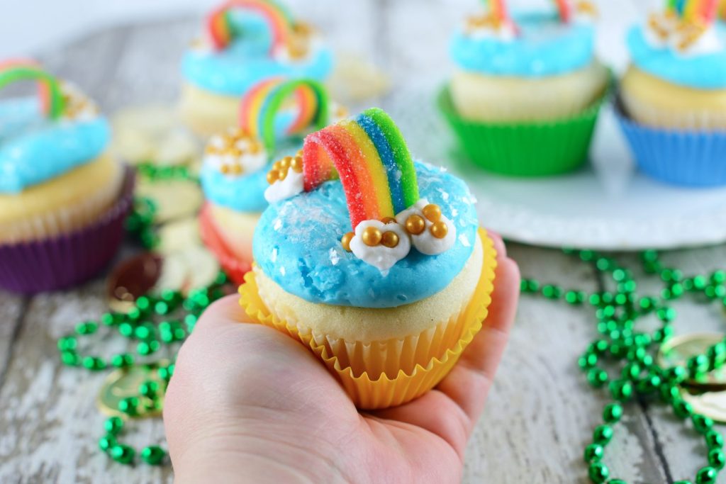 hand holding rainbow cupcake