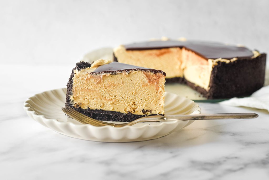 peanut butter cheesecake slice on a plate with a fork