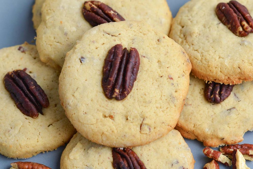 close up of a plate of pecan cookies