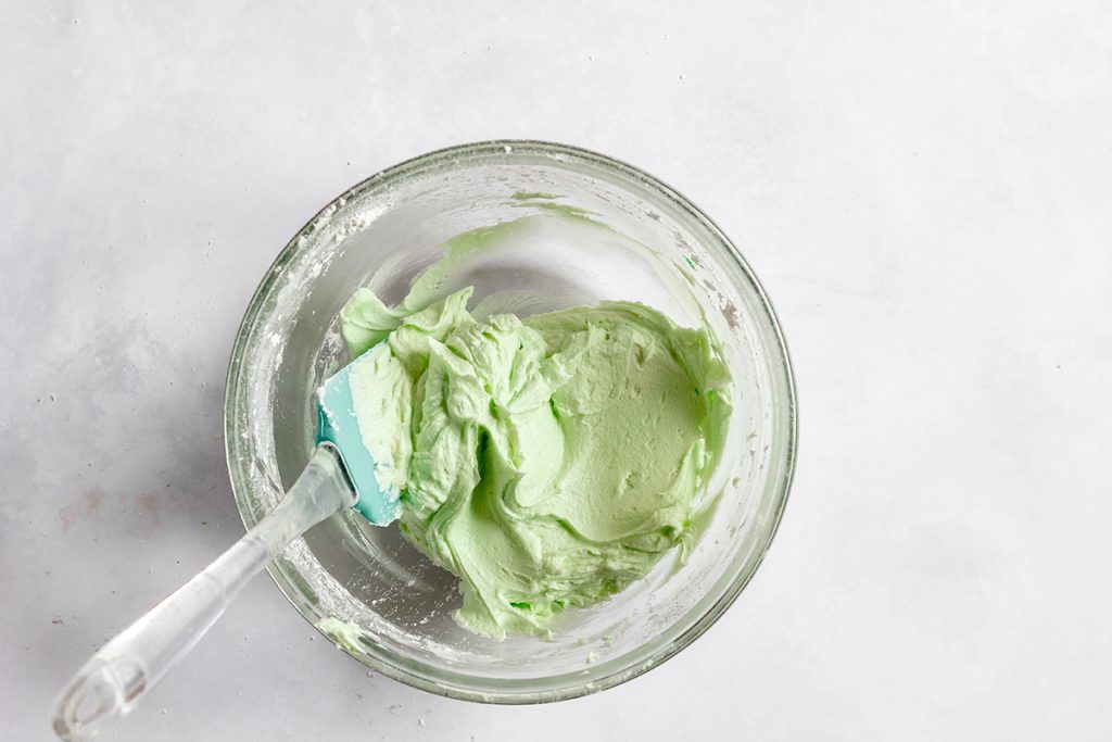 mint green frosting in a mixing bowl