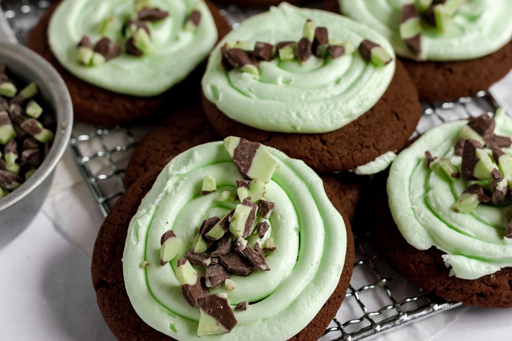 close up of chocolate mint cookies with green forsting.