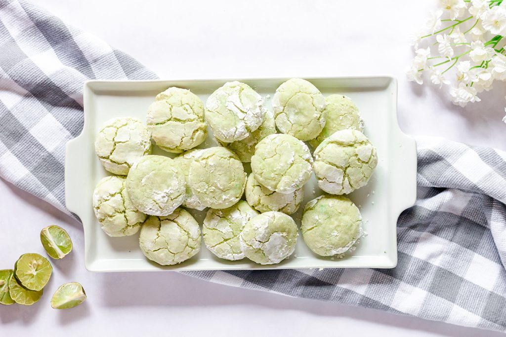 overhead shot of coconut key lime cookies on a white tray