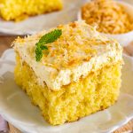 close up shot of pina colada poke cake on a plate