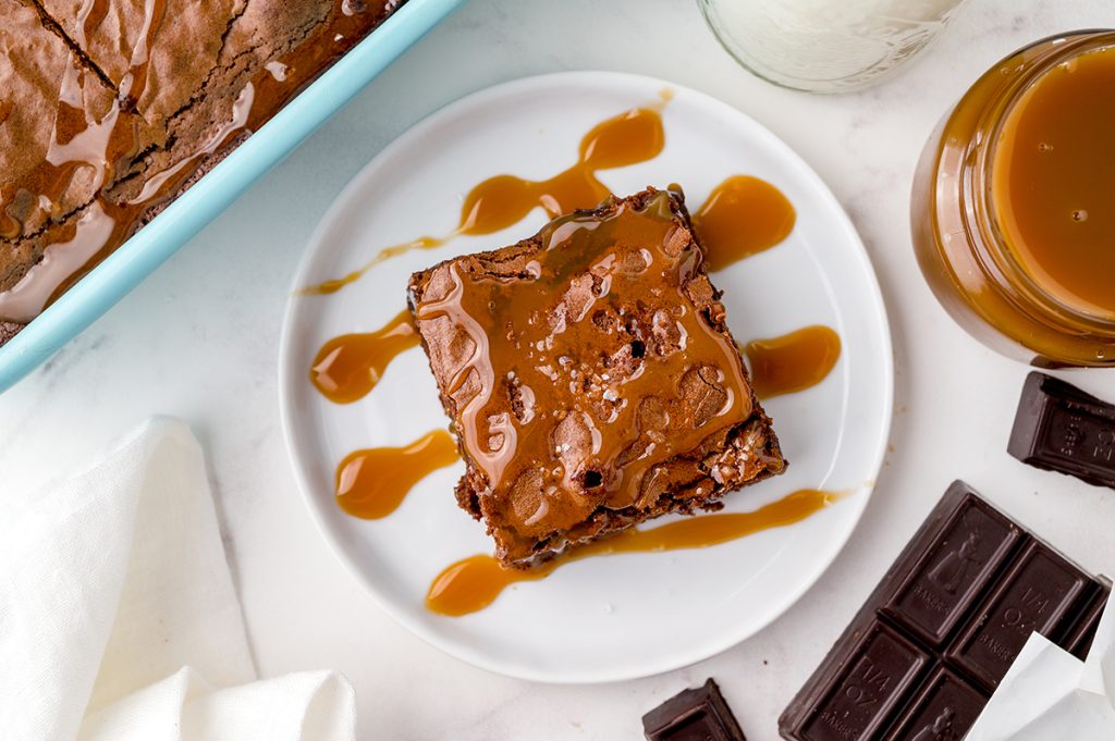 overhead shot of chewy brownie topped with caramel sauce