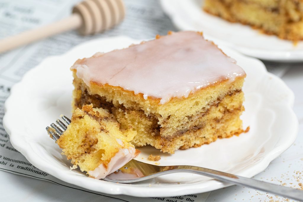 bite taken out of slice of honey bun cake