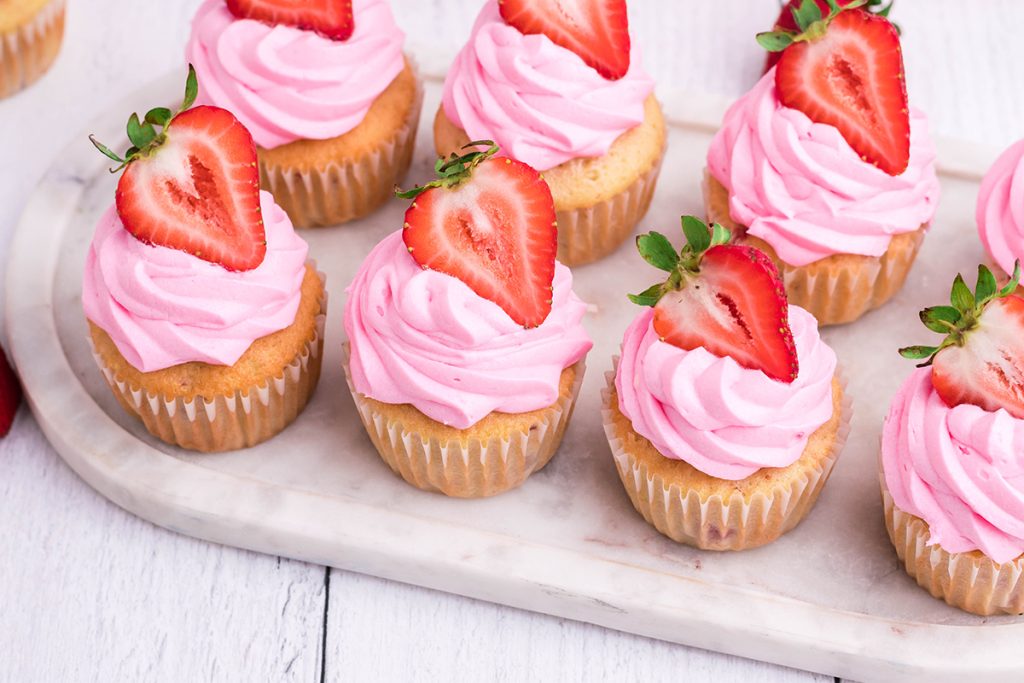 angled shot of tray of lemon strawberry cupcakes