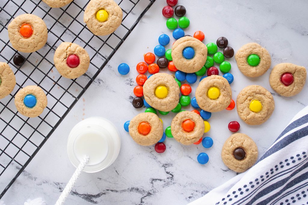 m&m peanut butter blossom cookies with a glass of milk