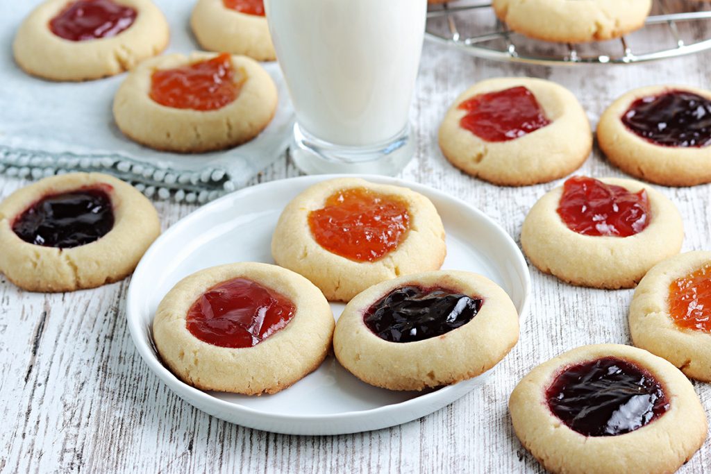 three thumbprint jam cookies on a plate