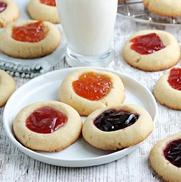 three thumbprint jam cookies on a plate