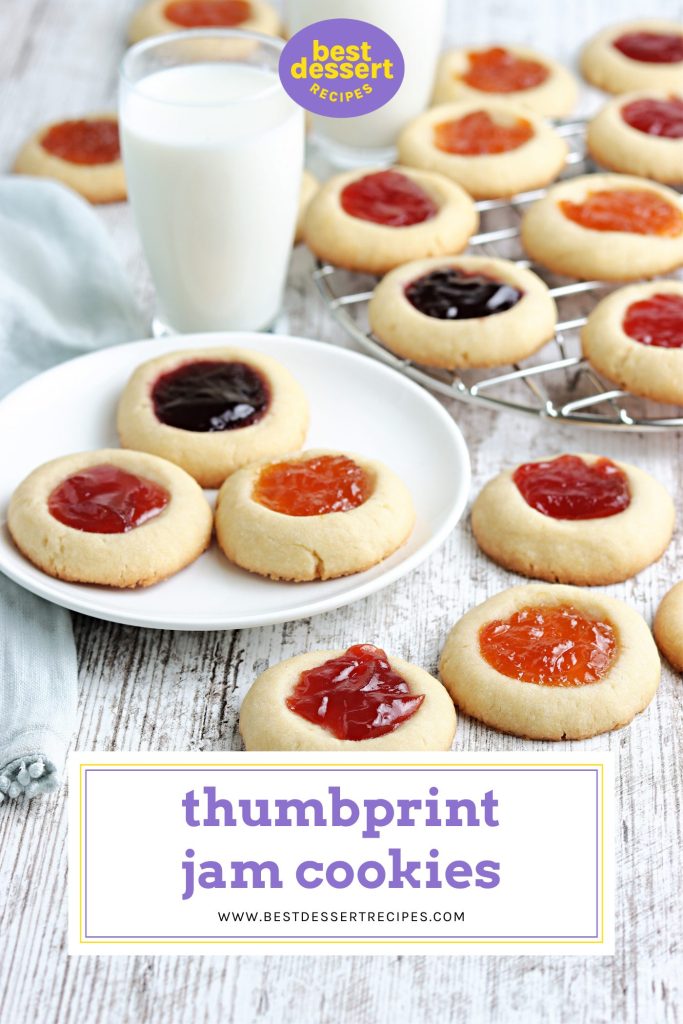 three thumbprint cookies on a plate with a glass of milk behind it with text overlay for pinterest