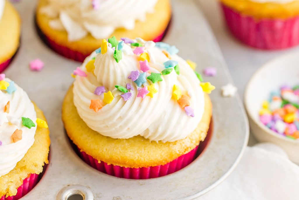 close up of vanilla cupcake in pan