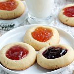 three thumbprint jam cookies on a plate