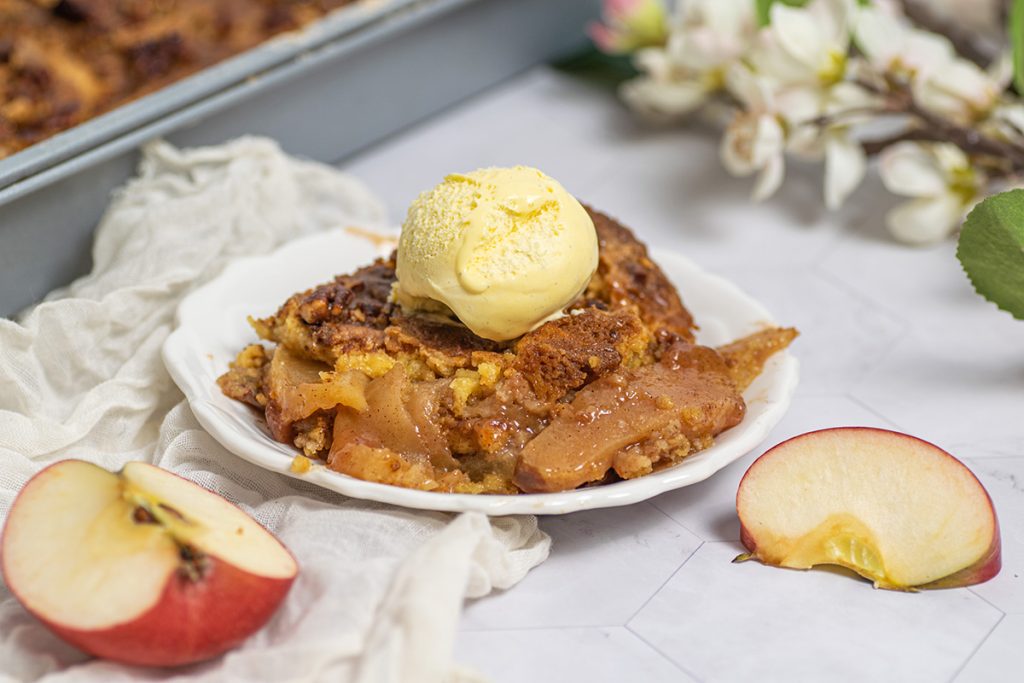 scoop of apple dump cake on a plate