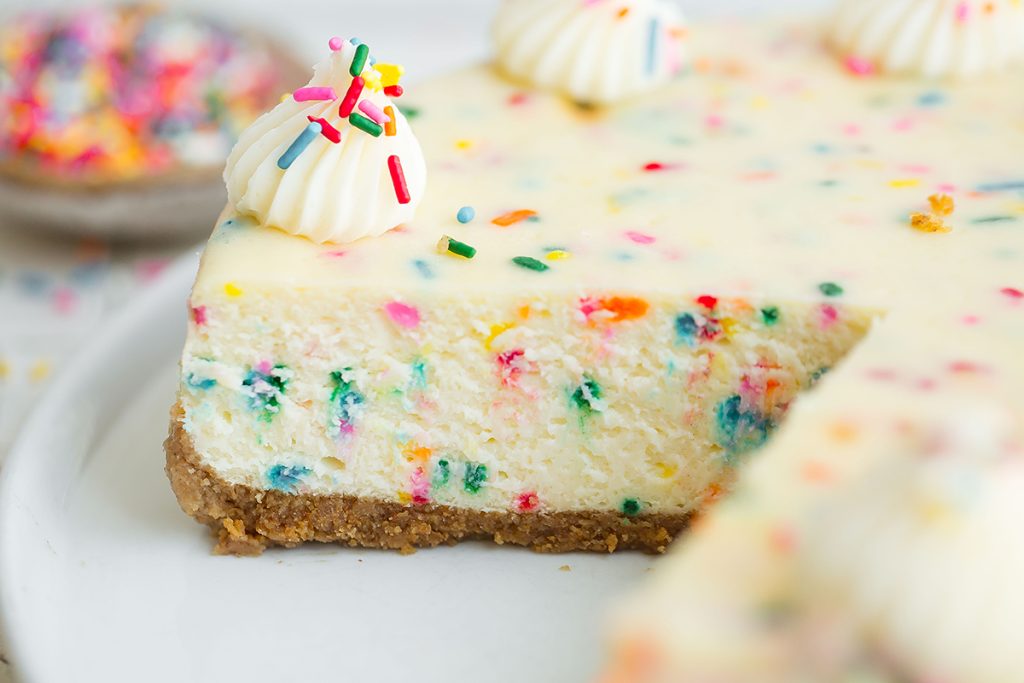 close up of sliced birthday cheesecake