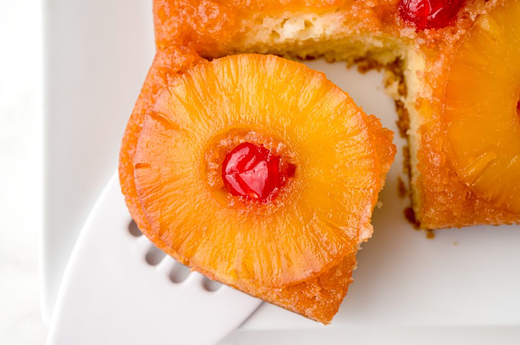 slice of pineapple upside down cake on spatula