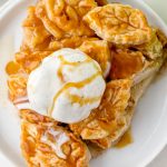slice of apple pie topped with ice cream