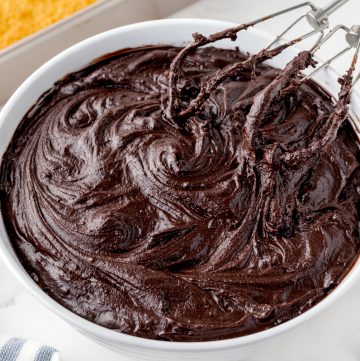 mixer mixing chocolate frosting in a bowl