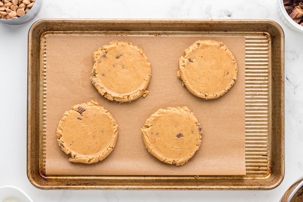 cookie dough disks on a cookie sheet