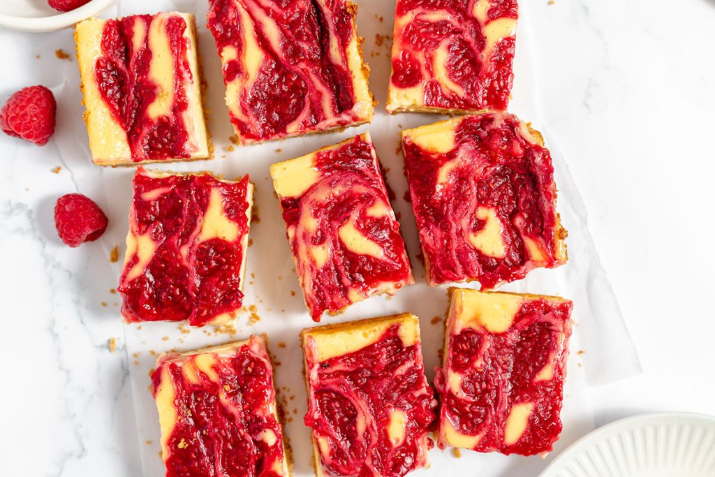 overhead shot of 9 sliced raspberry cheesecake bars