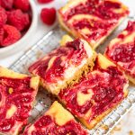 raspberry cheesecake bars on a wire rack