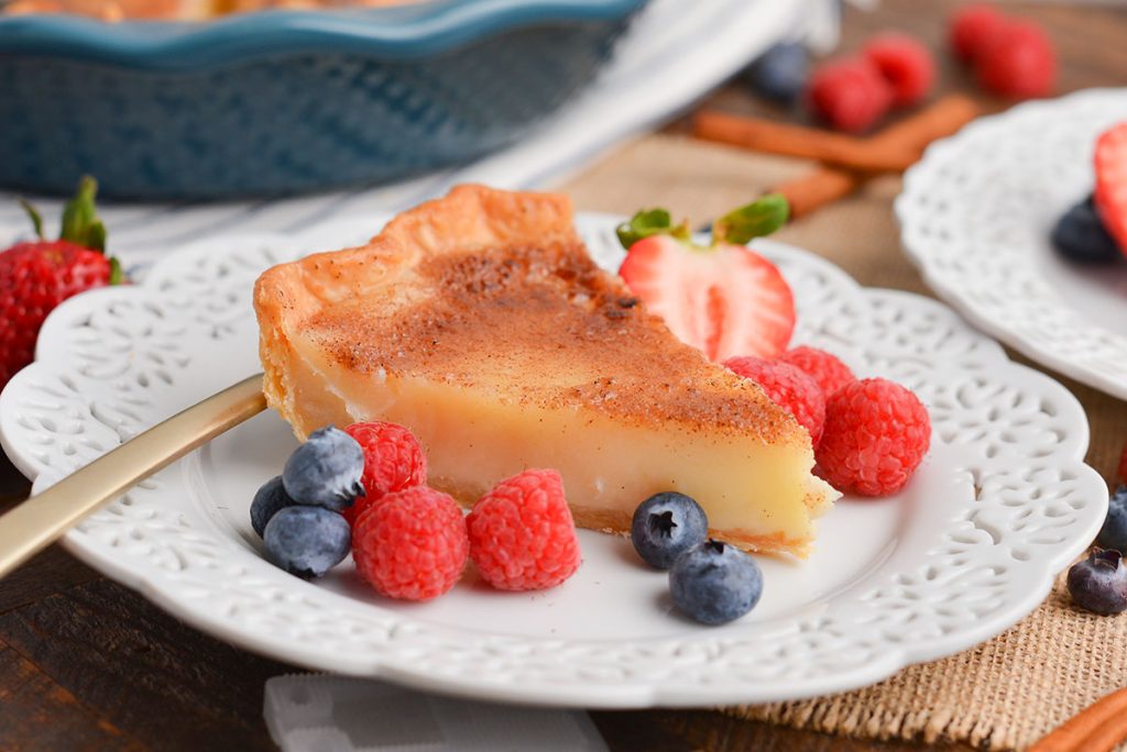 slice of creme brulee pie on plate with berries
