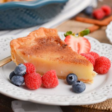 slice of creme brulee pie on plate with berries