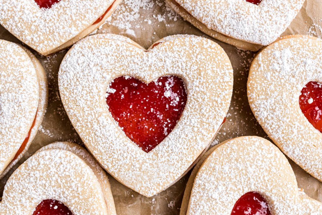 overhead close up shot of heart cookies on parchment paper