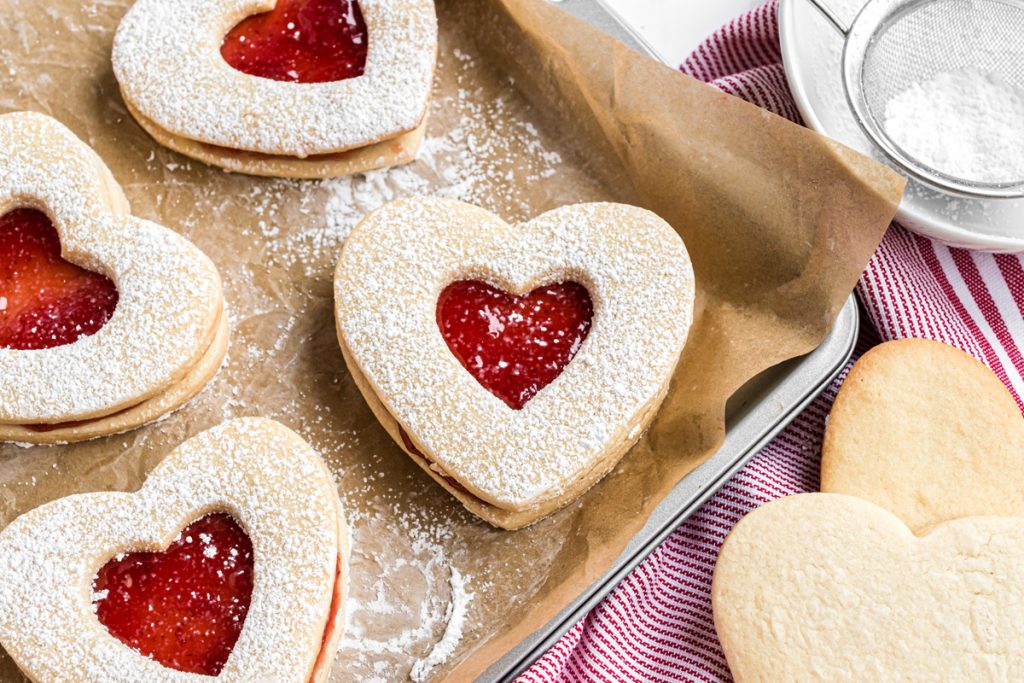 linzer cookies on baking sheet with parchment paper