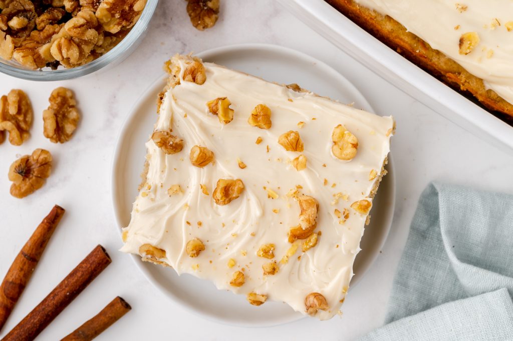 overhead shot of slice of cake topped with nuts