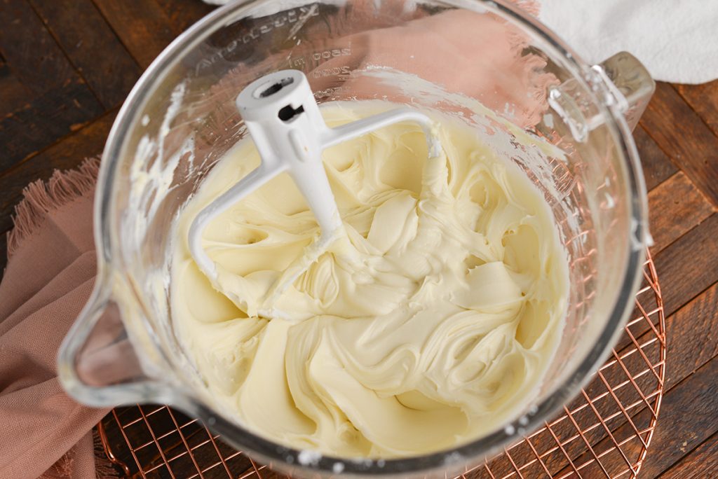 angled shot of cream cheese frosting in mixing bowl