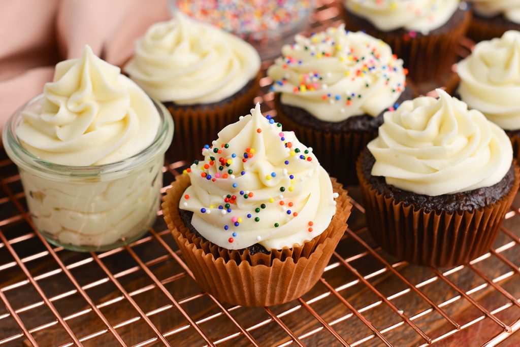 cupcakes topped with cream cheese frosting and sprinkles