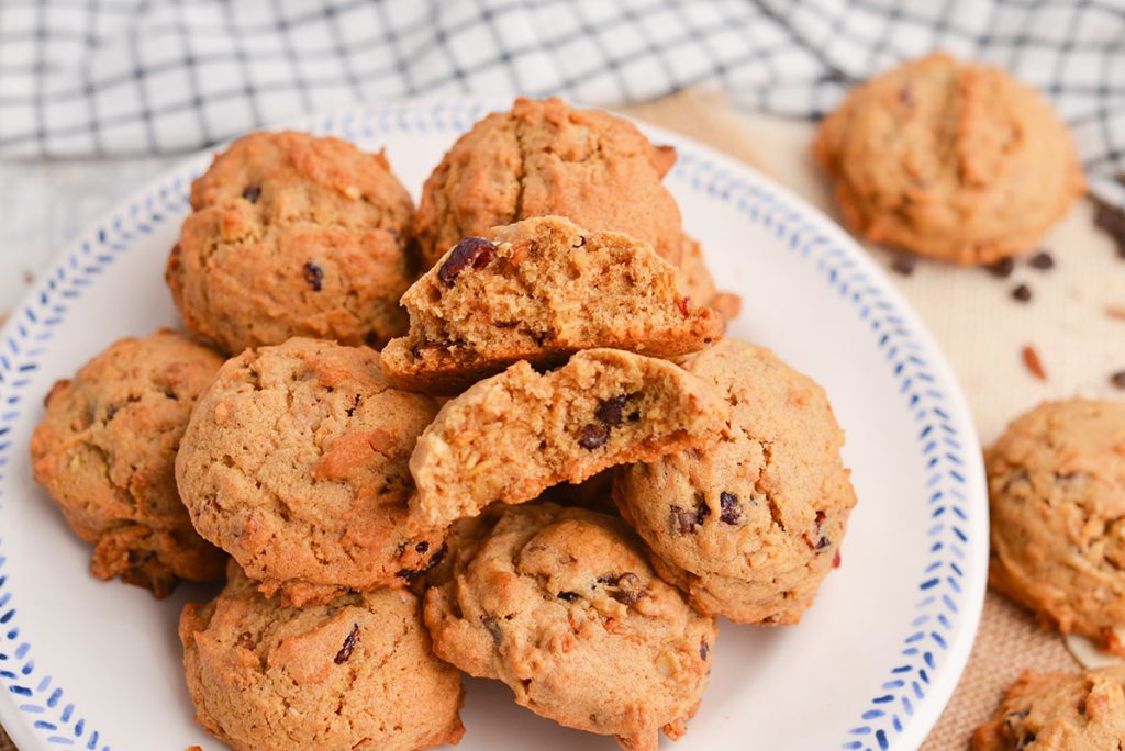 granola cookie broken in half on plate of granola cookies