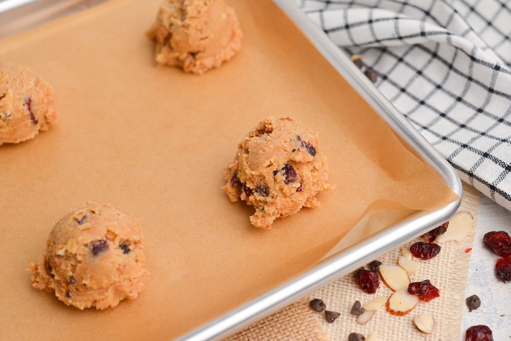 granola cookie dough balls on a cookie sheet