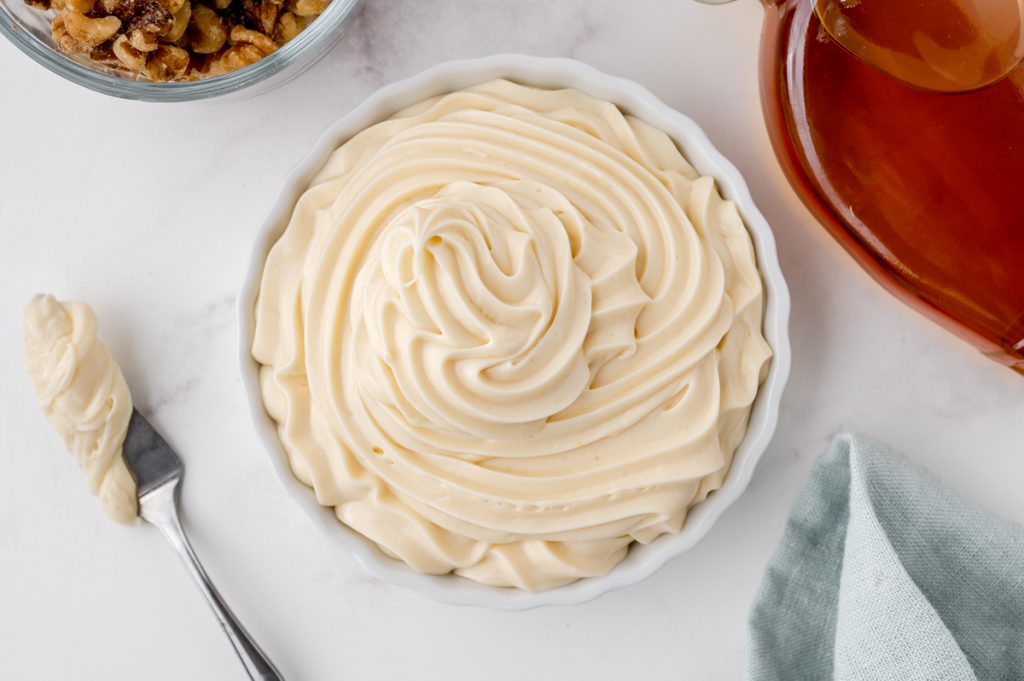 cream cheese frosting in white bowl