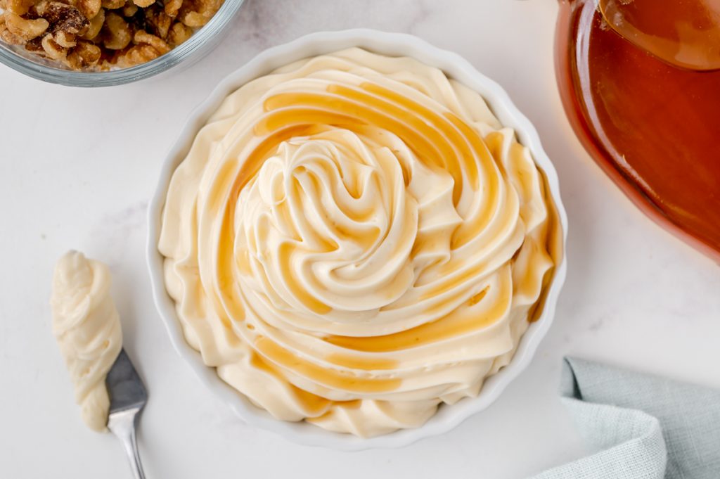 overhead shot of maple cream cheese frosting in bowl