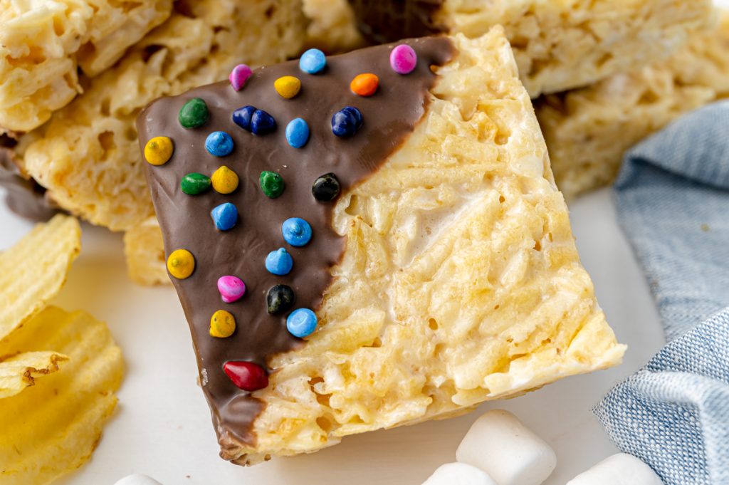 angled shot of one chocolate dipped potato chip marshmallow bar