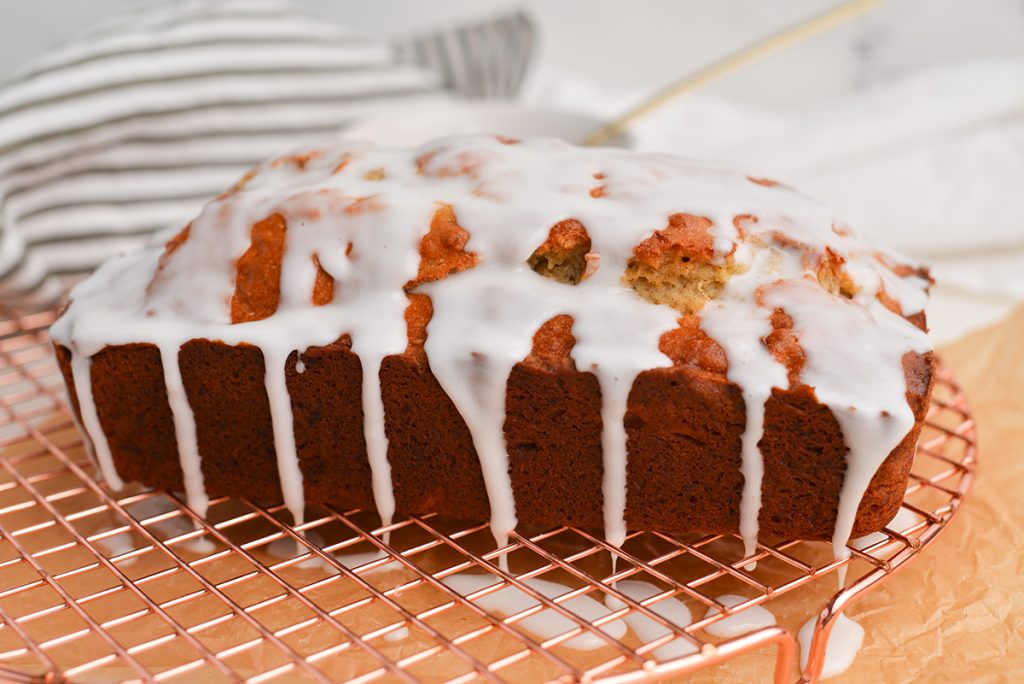 icing drizzled over banana bread loaf