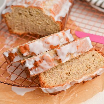 angled shot of sliced iced banana bread loaf